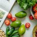 An appetizing display of fresh fruits and vegetables with a cookbook, perfect for healthy recipes.